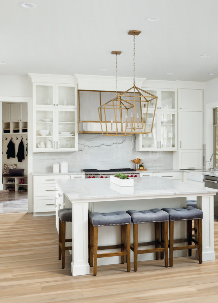Stone backsplash in a kitchen with gold light fixtures